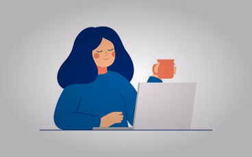 Woman in front of computer with mug