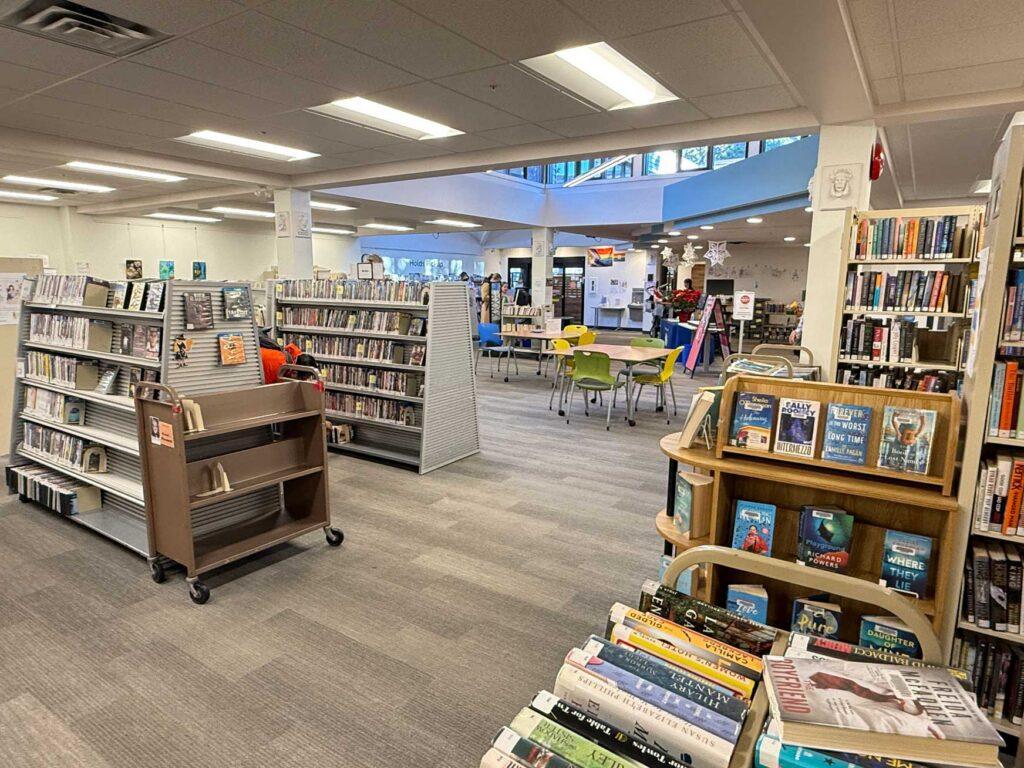 Interior shot of Oak Bay branch showing books and a table with chairs