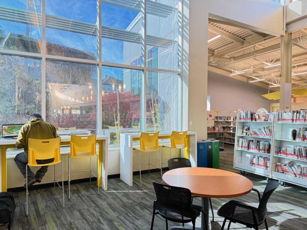 Interior shot of Saanich Centennial branch showing tables and windows