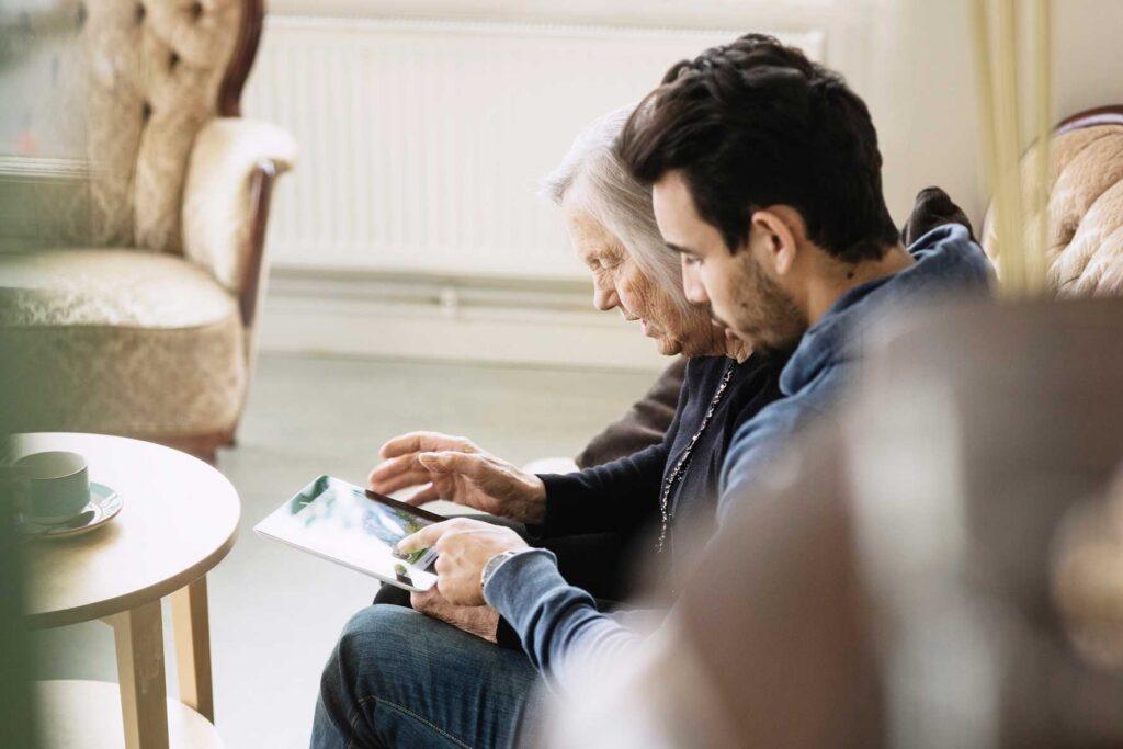 Young man helping older lady
