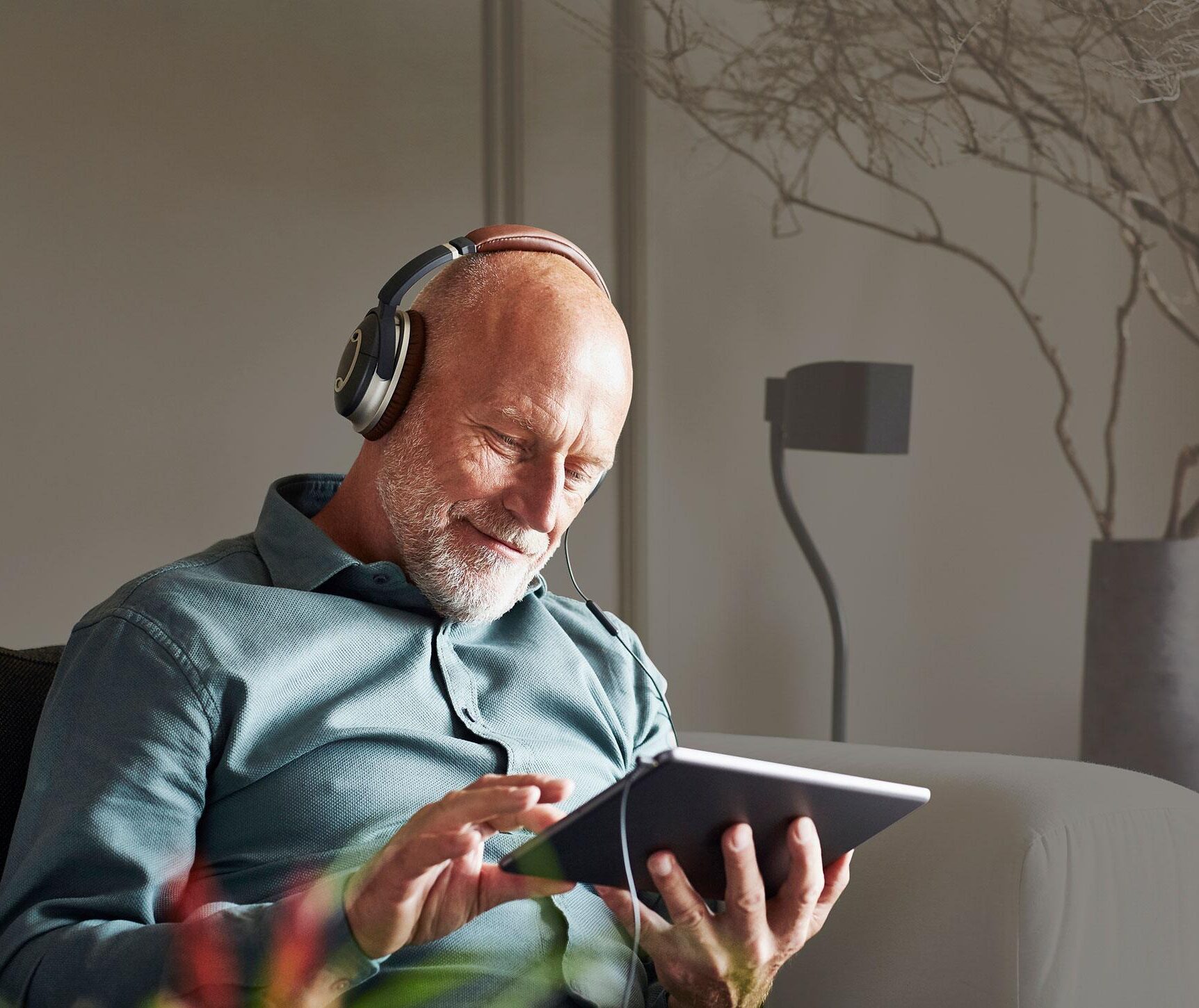 man with headphones and tablet