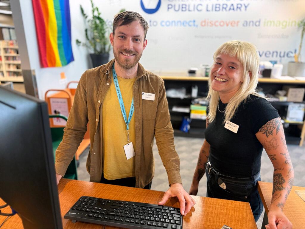 Male and female staff members smiling