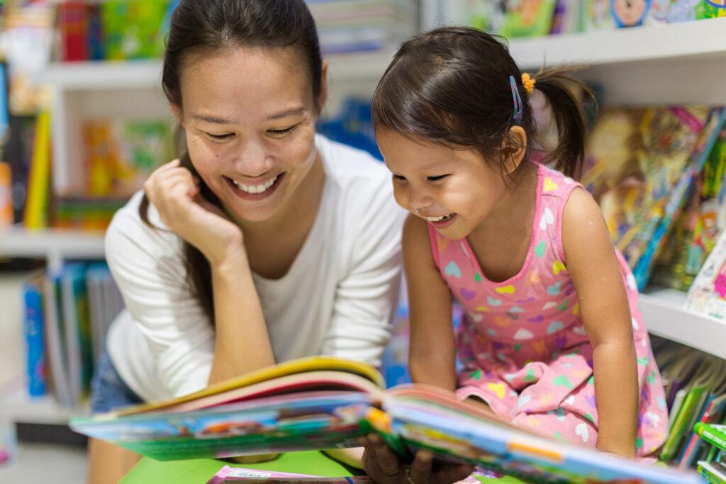 girl and mom reading in the library