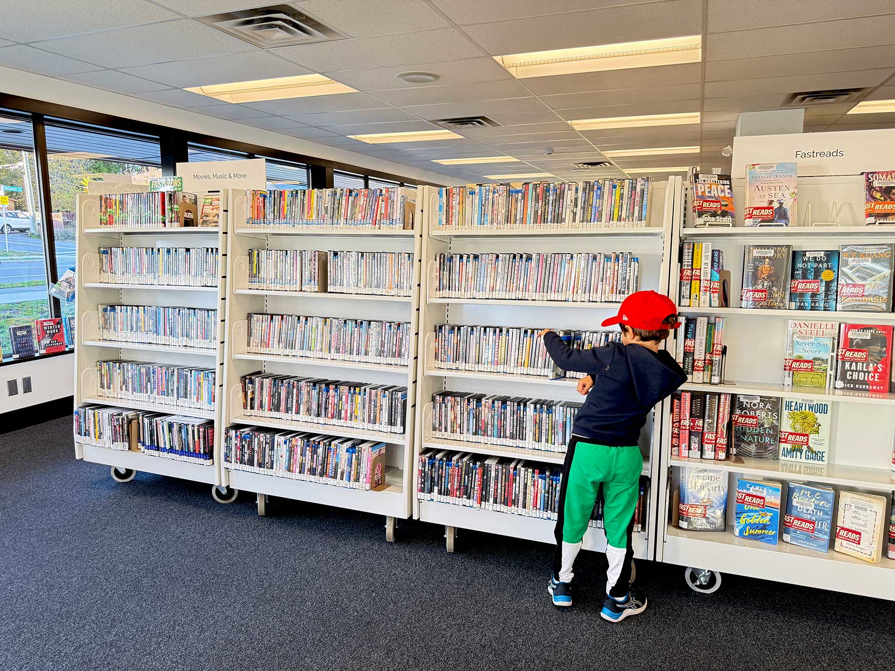Nellie McClung Express branch interior - a boy is browsing the media stacks