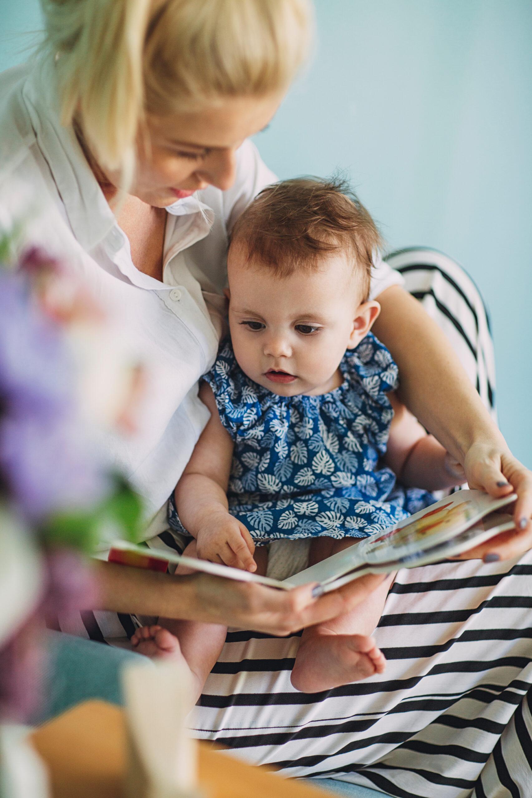 a woman reads to a young child who is in her lap