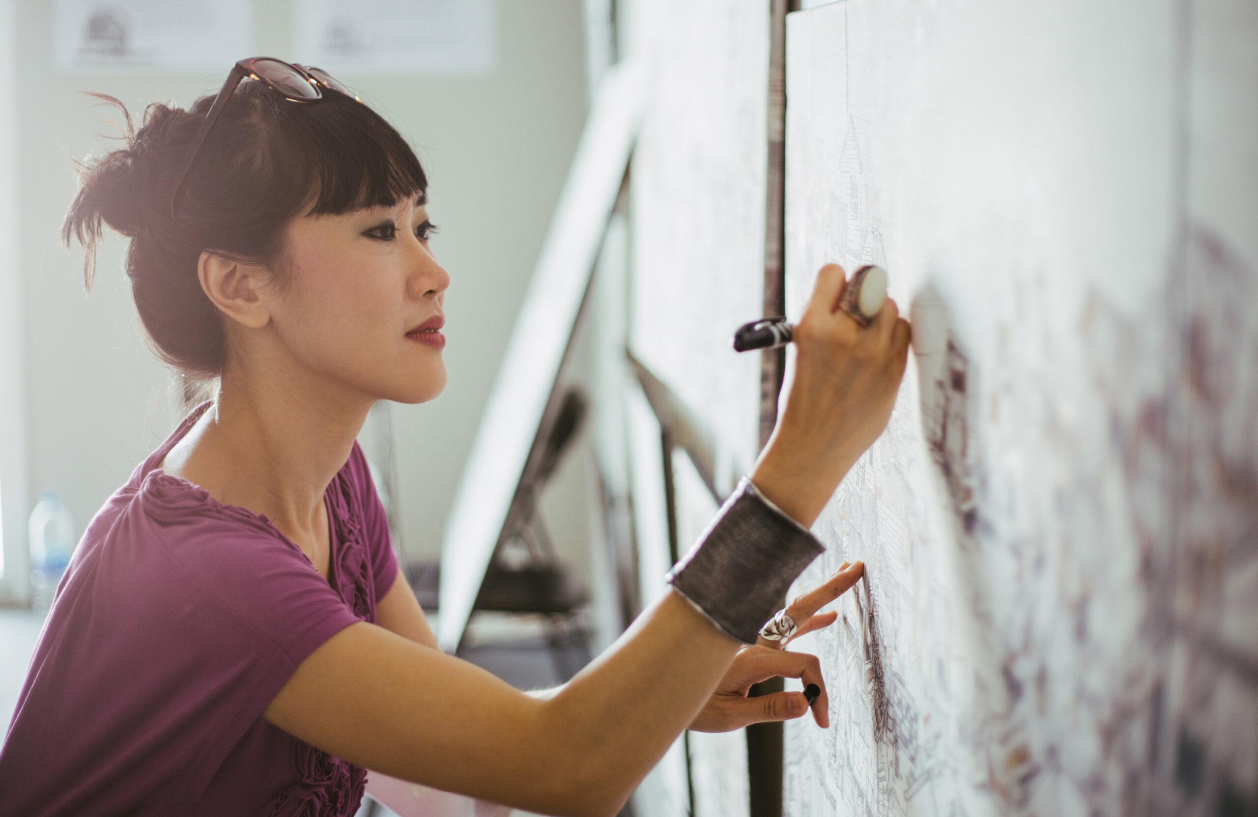 woman writing on board
