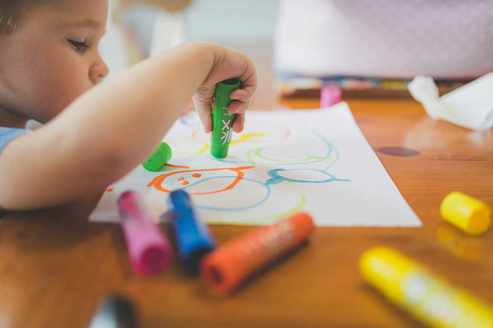 Child colouring on table