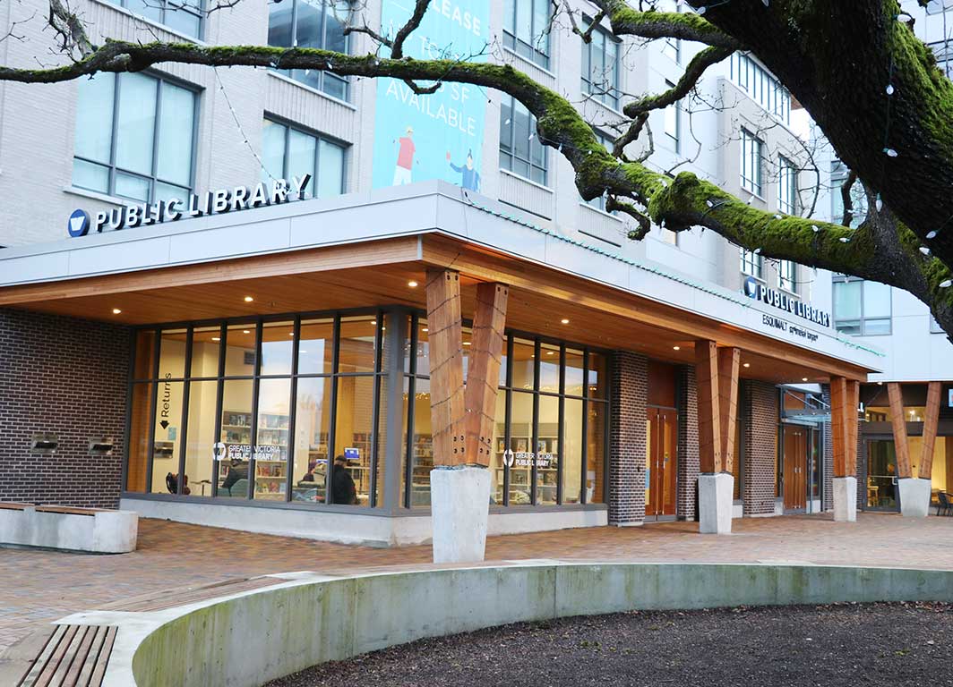 Esquimalt Branch exterior with tree in the foreground and building with wooden beams and giant windows.